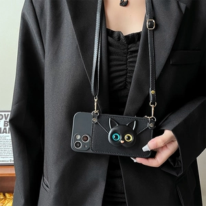 Detail of leather phone case with 3D cat card holder and adjustable crossbody strap