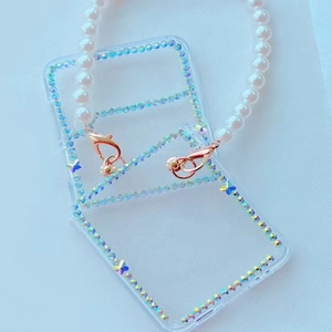 Transparent Samsung Z Flip case with rhinestones and white pearl wrist strap