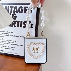 Detail of white Galaxy Z Flip case with pearl heart frame and elegant pearl handle strap