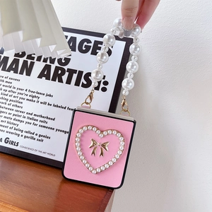 Close-up of pink leather phone case for Samsung ZFlip with pearl heart and bow detail