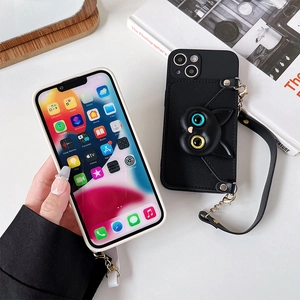 Detail of black leather iPhone case with cat card slot and gold chain wrist strap