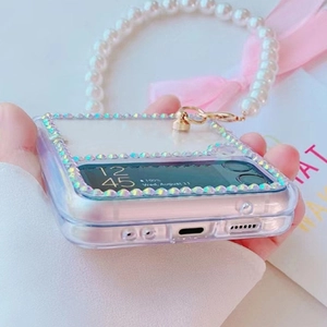 Detailed view of clear Samsung Z Flip case with gradient rhinestones and pearl handle
