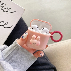 Detail of pink silicone AirPods case featuring 3D rabbit doll and pink metal carabiner