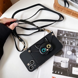 Detail of crossbody phone case with adjustable leather strap and 3D cat charm decoration