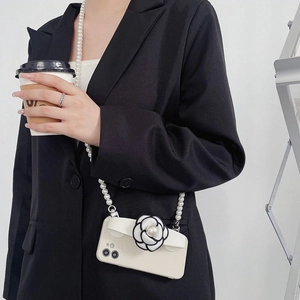 Crossbody iPhone case featuring camellia flower detail and elegant pearl shoulder strap