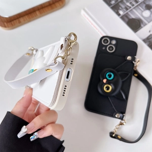 Detail view of iPhone leather cases with 3D cat decor, card slot and wrist strap