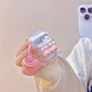 Clear AirPods case with three pink bunnies and a heart smiley pendant in mirror selfie