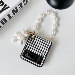 Detail of Galaxy Z Flip case with houndstooth pattern, pearl handle and puppy charm