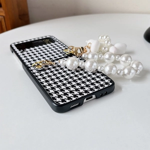 Detail of Galaxy Z Flip case with houndstooth texture and pearl handle attachment