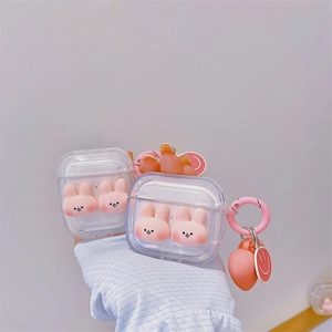 Transparent AirPods case featuring cute 3D pink bunnies with a peach keychain and hook