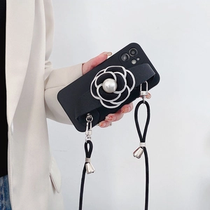 Detail of black iPhone case with camellia pearl wrist strap and crossbody lanyard