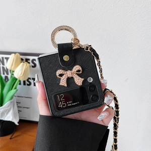 Detail of Galaxy Z Flip case with pearl bow and rhinestone ring on a woven crossbody chain