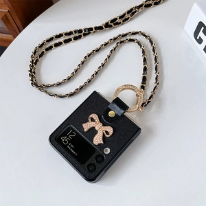 Detail of Galaxy Z Flip phone case with pearl bow decor and metal chain crossbody strap