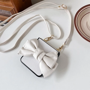 Detail of white cross-body mini bag with large bow and gold metal hooks for Samsung ZFlip