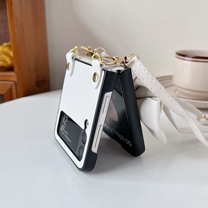 Detailed view of white leather Z Flip 3 case with luxury bow and gold crossbody strap