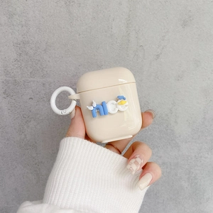 Detailed close-up of cream silicone AirPods case with 3D blue nice lettering and a ring clip