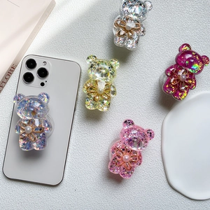 Close-up of bear phone grip with holographic sequins, pearl and golden flower detail