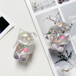 Close-up of bear-shaped phone grip with strawberry sequins and clear resin texture
