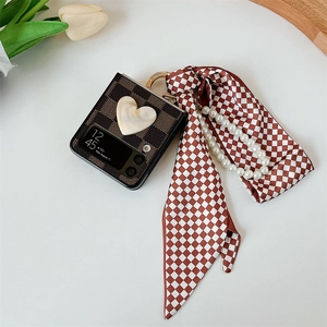 Detail of Z Flip phone case with checkered pattern, pearl chain and ribbon handle