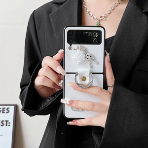 Luxury Galaxy Z Flip case with 3D white roses, diamond bear, and rhinestone ring holder