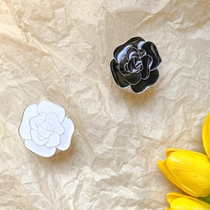 Detailed close-up of premium enamel flower phone socket in black and white finishes