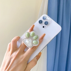 Detailed view of a mint green cat paw phone socket with sparkling resin and rhinestones