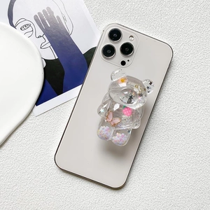 Cute transparent bear phone socket with glitter, flowers and butterfly on white smartphone