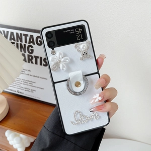 Detail of luxury Z Flip case featuring rhinestone bear, pearl flower and ring holder
