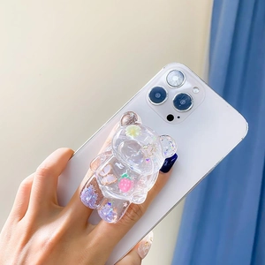 Detail of transparent bear phone grip with glitter, flowers and butterfly inserts