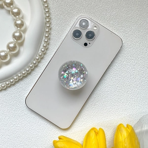 Glittery crystal phone socket grip on white mobile back with tulip and pearl accents