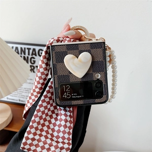 Detail of Galaxy Z Flip case with retro checkerboard, 3D heart and pearl handle strap