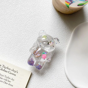 Macro view of transparent bear phone grip with purple glitter and pink butterfly details