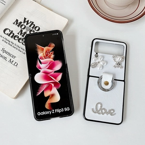 Detailed view of luxury white Z Flip case with rhinestone bear, flower and ring holder