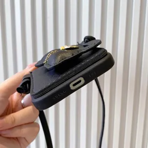 Black litchi leather crossbody iPhone case with card holder and gold chain strap