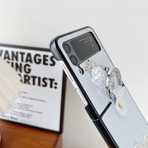 Detail of luxury foldable Z Flip case with white rose flower and rhinestone ring holder