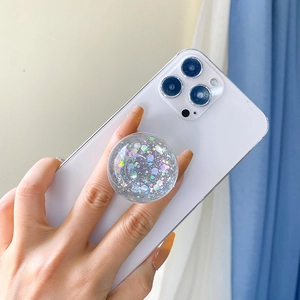 Close-up of a circular phone socket with colorful laser sequins on a white smartphone