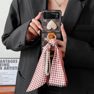 Retro checkerboard Galaxy Z Flip 3 case with heart detail, silk ribbon and pearl chain