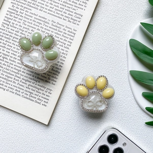 Detail of cute cat paw phone grip with sparkling rhinestones and crystal resin finish