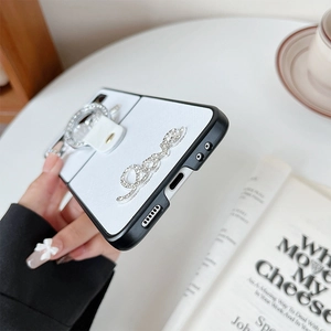 Detail view of folding phone case with luxury rhinestone bear and ring holder handle