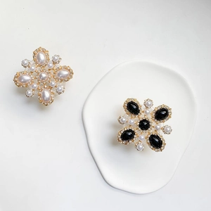 Baroque floral phone grip with rhinestones and pearls on a white ceramic tray