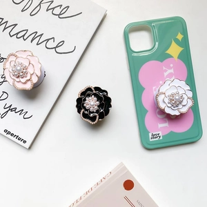 Luxury camellia flower phone socket with pearls and rhinestones on a green floral case