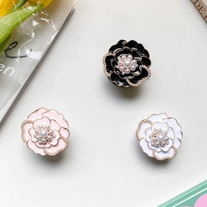 Detailed close-up of pearl camellia flower phone sockets in black, pink, and white