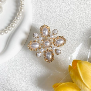 Detailed view of luxury rhinestone and pearl phone socket grip on elegant floral background