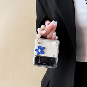 Clear Galaxy Z Flip case with 3D floral accents and pearl wrist strap handle