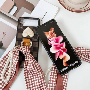 Detail of Galaxy Z Flip3 case with retro checkerboard, pearl handle and silk scarf