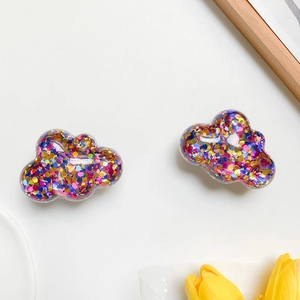 Macro detail of cloud-shaped phone holders filled with vibrant colorful sequins