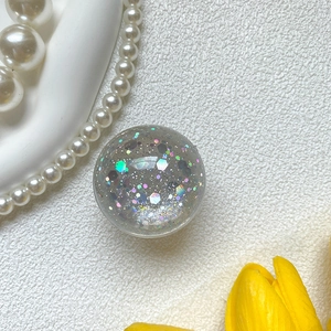 Macro view of crystal glitter ball phone socket with colorful sequins and sparkles