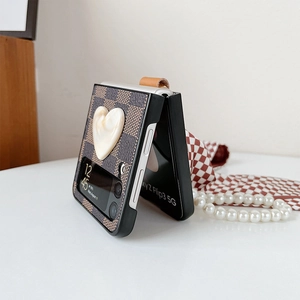 Detail of Z Flip3 case featuring brown checkerboard pattern and 3D heart ornament