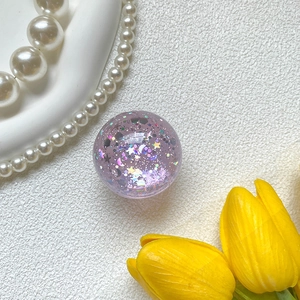 Close-up of a purple glittery phone socket with sparkling star and moon sequins