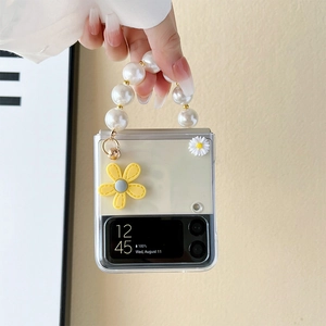 Detail of transparent foldable phone case with daisy flowers and white pearl handle strap